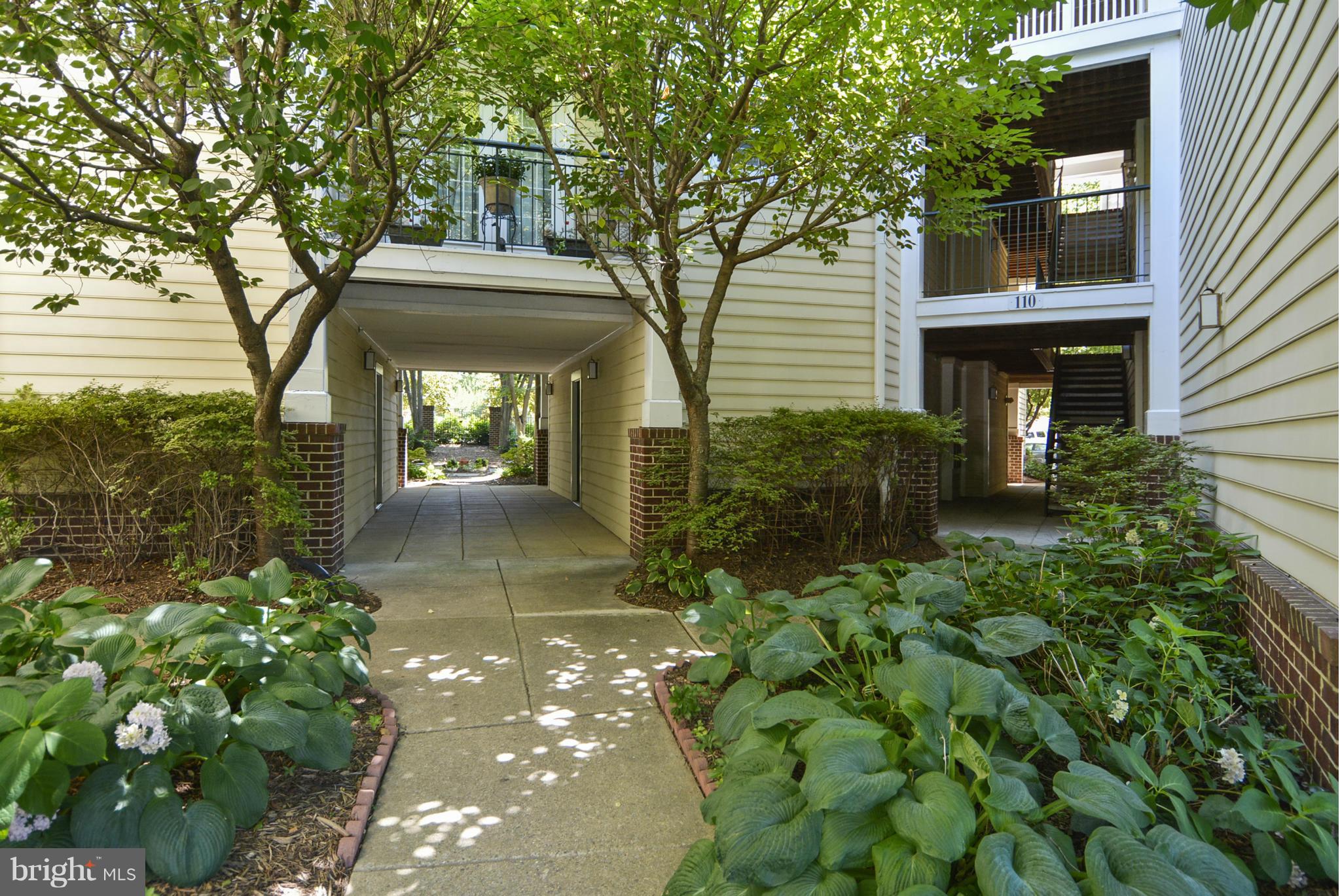 110 Booth Street, Unit 28 Gaithersburg, MD 20878 - Photo 23 of 30 a front view of a house with a yard