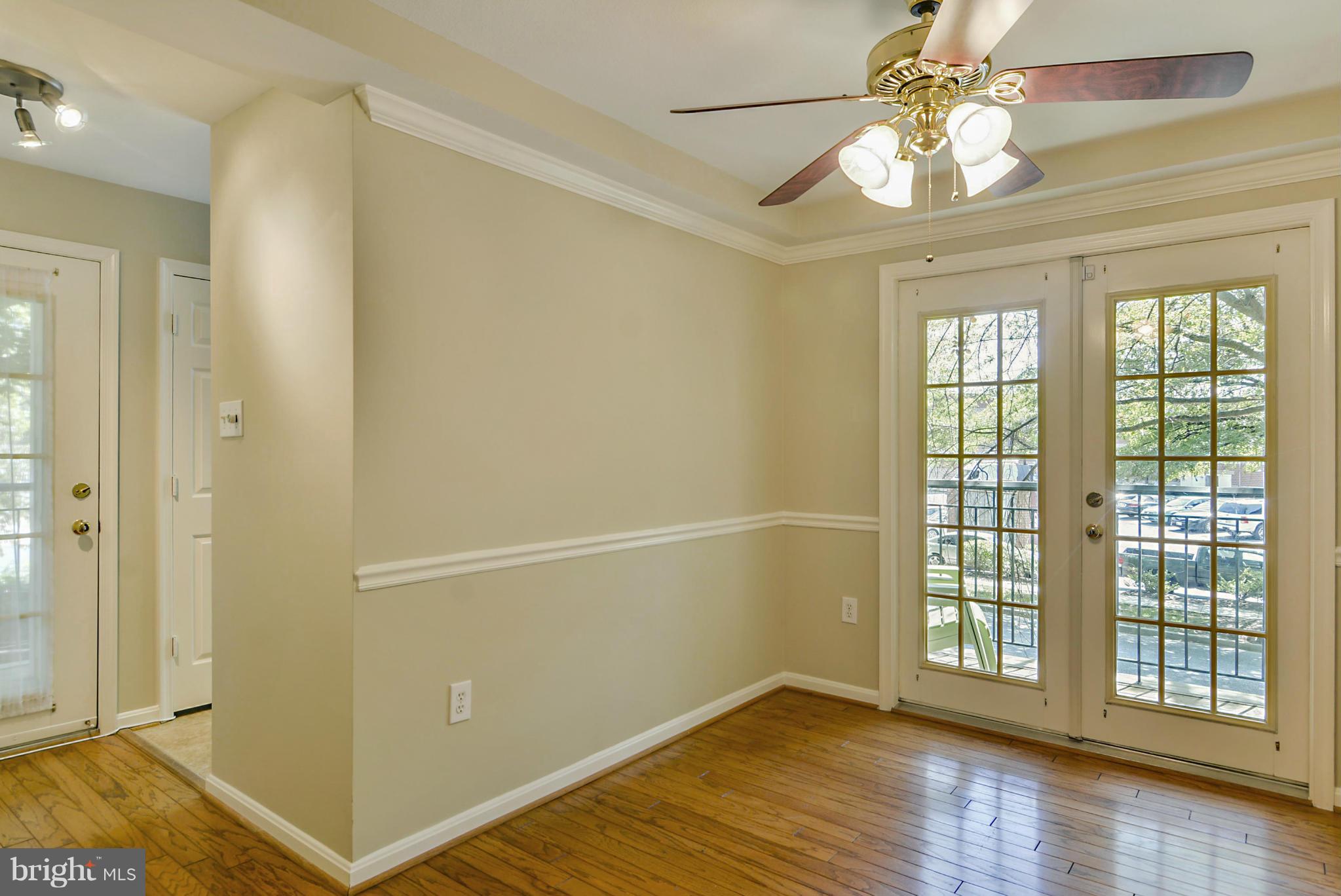 110 Booth Street, Unit 28 Gaithersburg, MD 20878 - Photo 4 of 30 an empty room with wooden floor fan and windows