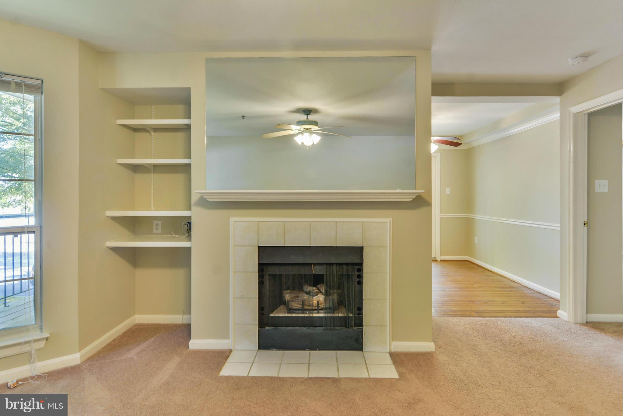 110 Booth Street, Unit 28 Gaithersburg, MD 20878 - Photo 7 of 30 a living room with a fireplace and a glass door