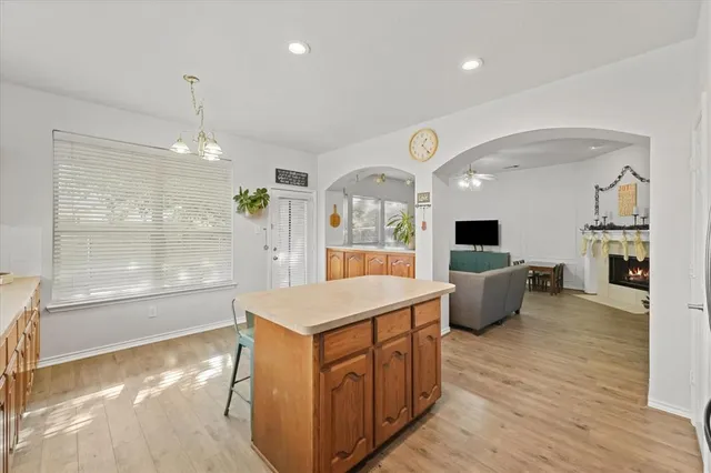 a living room with furniture a flat screen tv and a large window