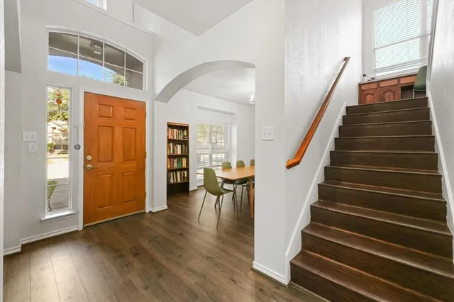 a view of entryway and hall with wooden floor