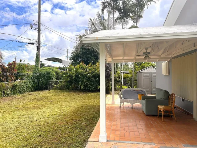 a view of a patio with table and chairs and potted plants