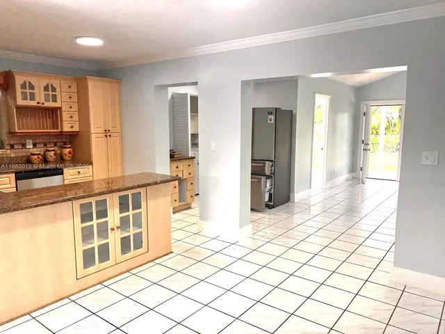 a view of a large room with wooden floor and windows