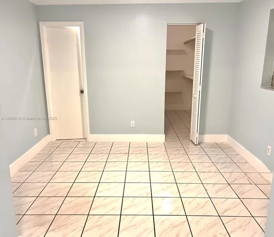 a view of a bedroom and an empty room