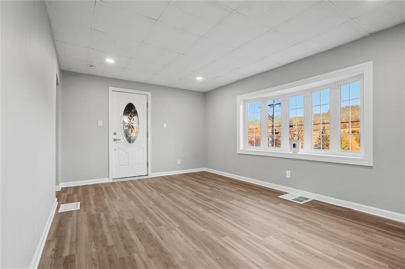 803 Little Deer Creek Valley Road Russellton, PA 15076 - Photo 6 of 46 a view of an empty room with window and wooden floor