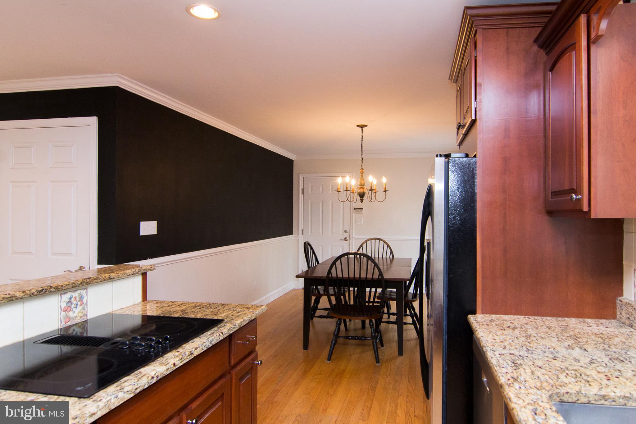 15825 Yeoho Road Sparks, MD 21152 - Photo 11 of 30 a kitchen with granite countertop sink stainless steel appliances and dining table