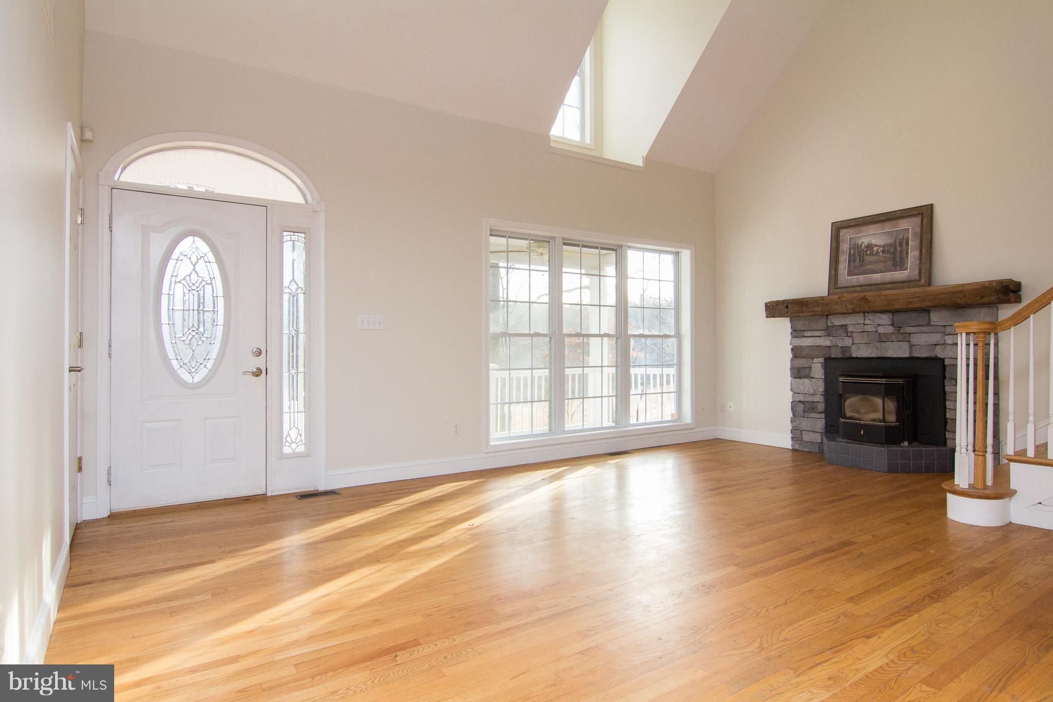 15825 Yeoho Road Sparks, MD 21152 - Photo 5 of 30 a view of empty room with wooden floor and fireplace