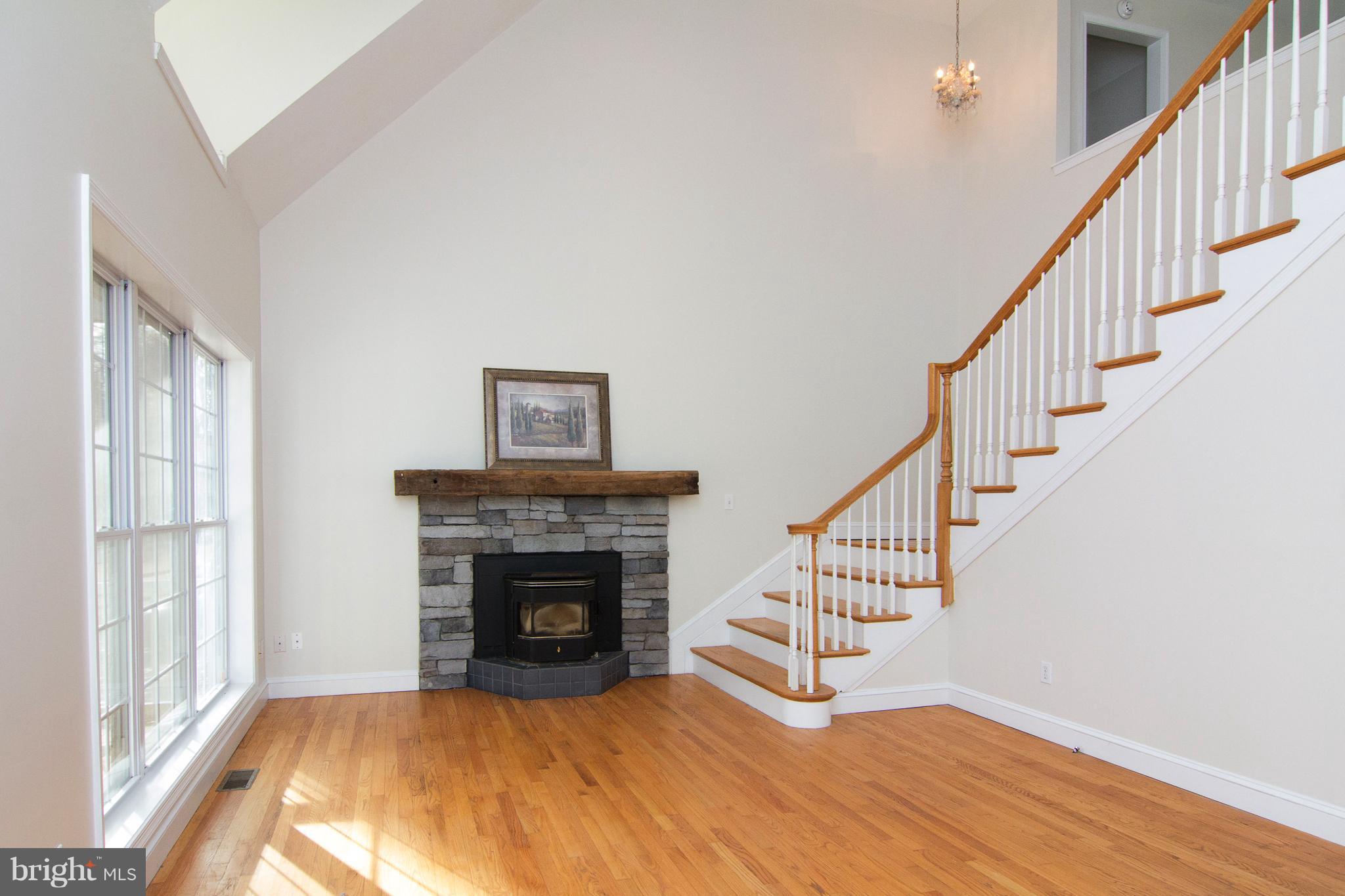 15825 Yeoho Road Sparks, MD 21152 - Photo 7 of 30 a view of an empty room with wooden floor fireplace and a window