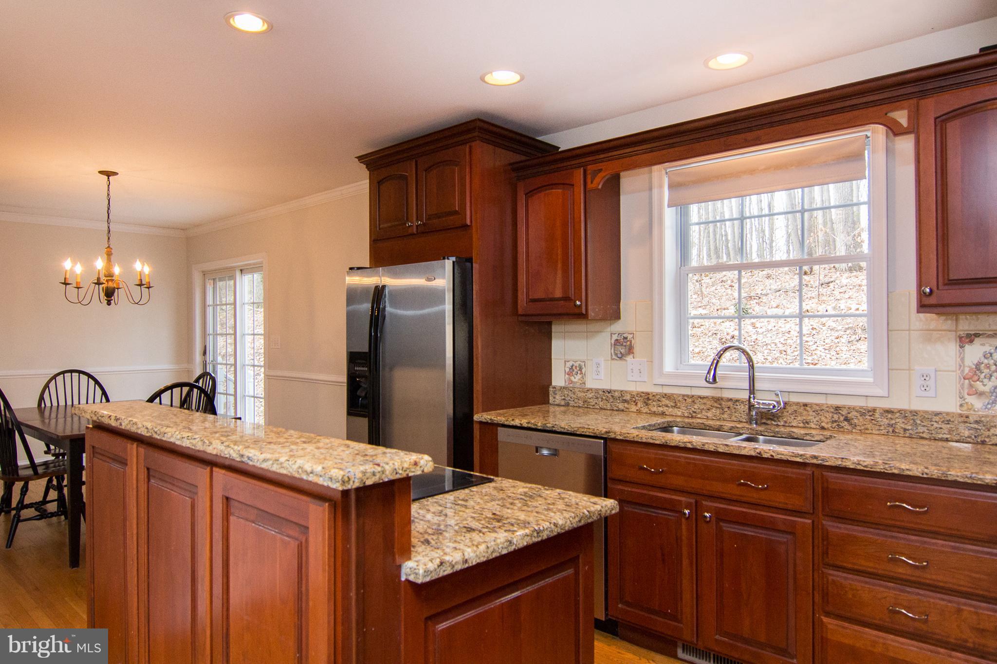 15825 Yeoho Road Sparks, MD 21152 - Photo 9 of 30 a kitchen with stainless steel appliances granite countertop a sink stove and refrigerator