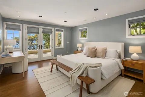 a bedroom with a large bed and a chandelier