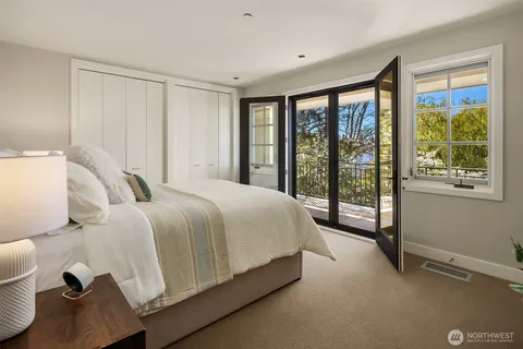 a spacious bedroom with a large bed and a large window
