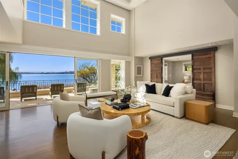 a living room with fireplace furniture and a large window