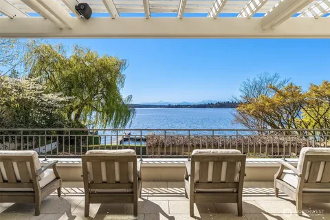 a view of roof deck with couches and potted plants