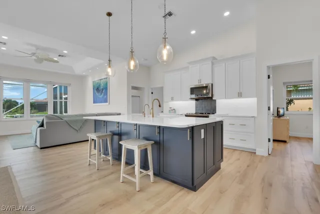 a kitchen island with cabinets and wooden floor