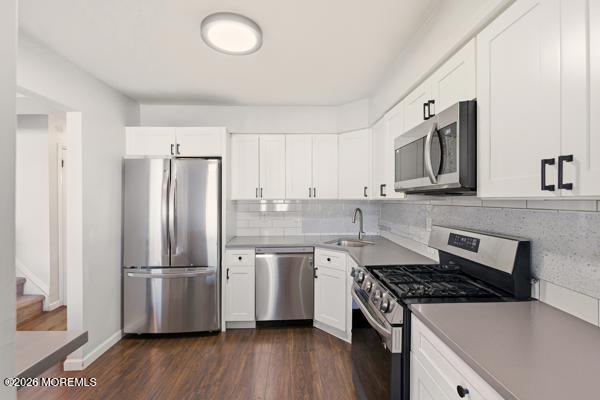 7 Tracey Court Howell, NJ 07731 - Photo 17 of 20 a kitchen with stainless steel appliances a refrigerator a sink and wooden floors