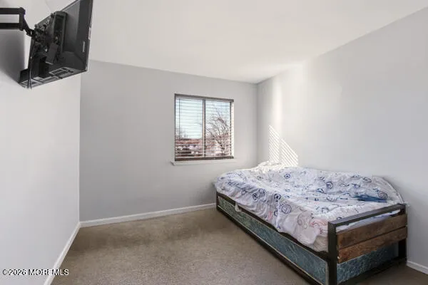 a bedroom with a bed and dresser