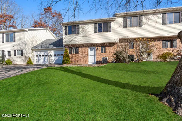 a front view of a house with a garden and yard