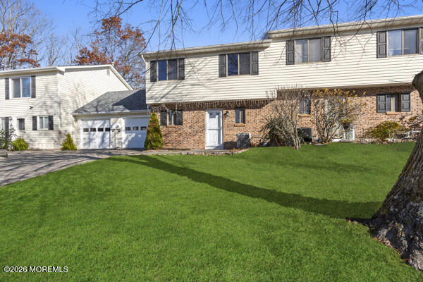 7 Tracey Court Howell, NJ 07731 - Photo 5 of 20 a front view of a house with a garden and yard