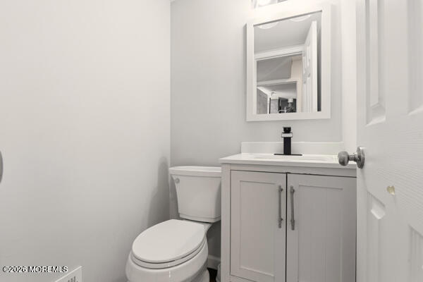 7 Tracey Court Howell, NJ 07731 - Photo 8 of 20 a bathroom with a toilet sink vanity and mirror