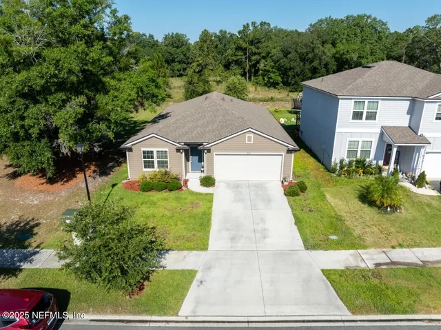 a aerial view of a house with a yard