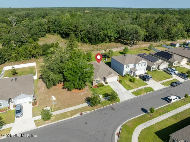 an aerial view of a house with a yard basket ball court