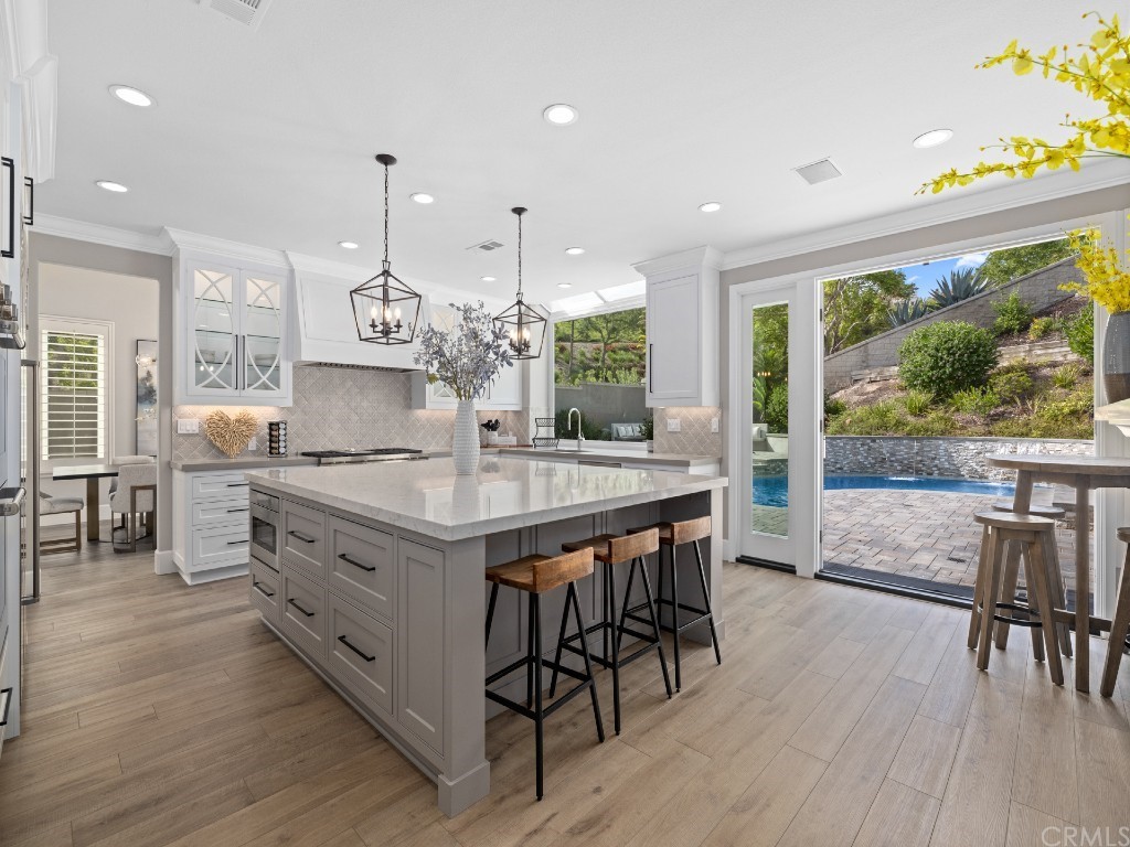 Newly remodeled kitchen with custom cabinetry, generous storage,a large island for mealtime prep and socializing, and pro-level Sub-Zero and Wolf appliances.