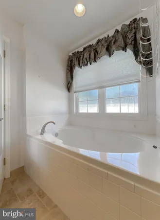 an empty room with an entryway and fan