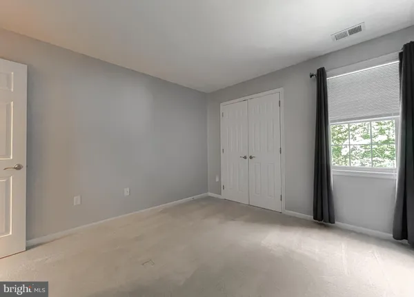 a view of an empty room and wooden floor