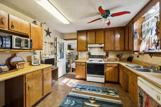a kitchen with a stove a sink and a refrigerator