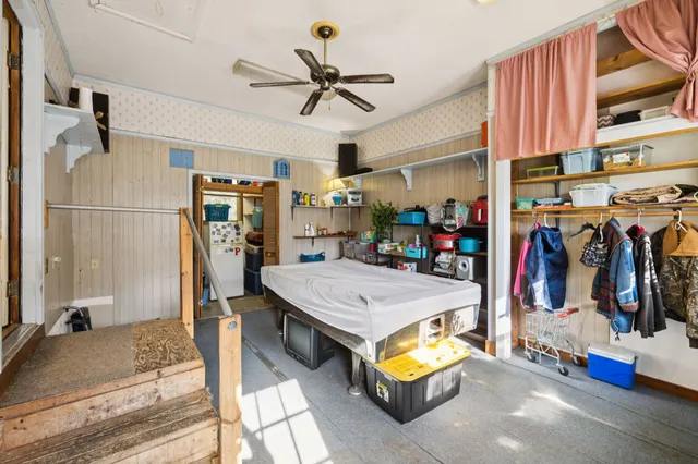 a view of a livingroom with furniture and a ceiling fan