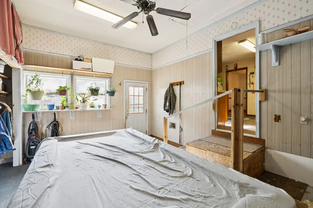 a bedroom with a bed and a mirror