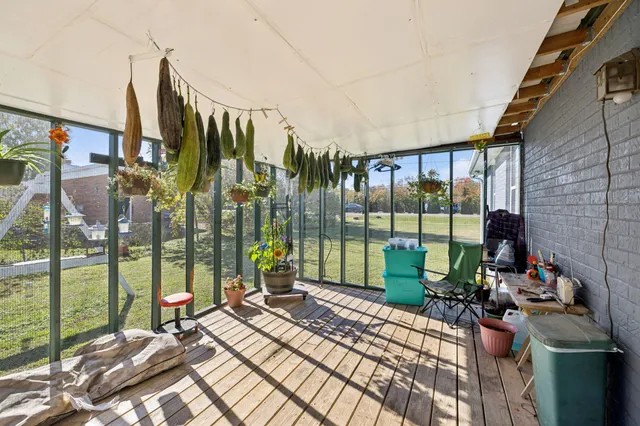 a view of a balcony with couch and wooden floor