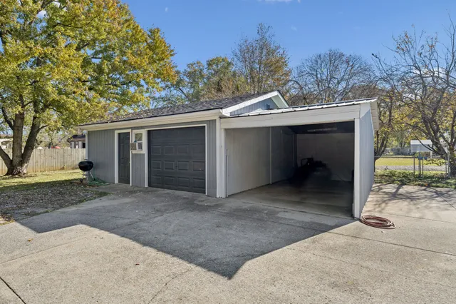 a view of a house with a yard and garage