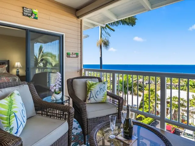 a balcony with furniture and wooden floor