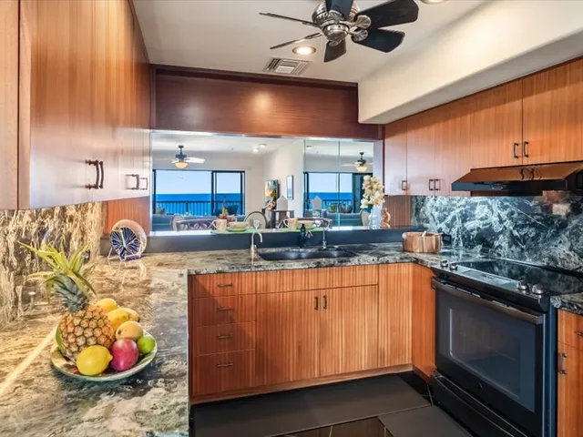 a kitchen with stainless steel appliances granite countertop a sink and a stove