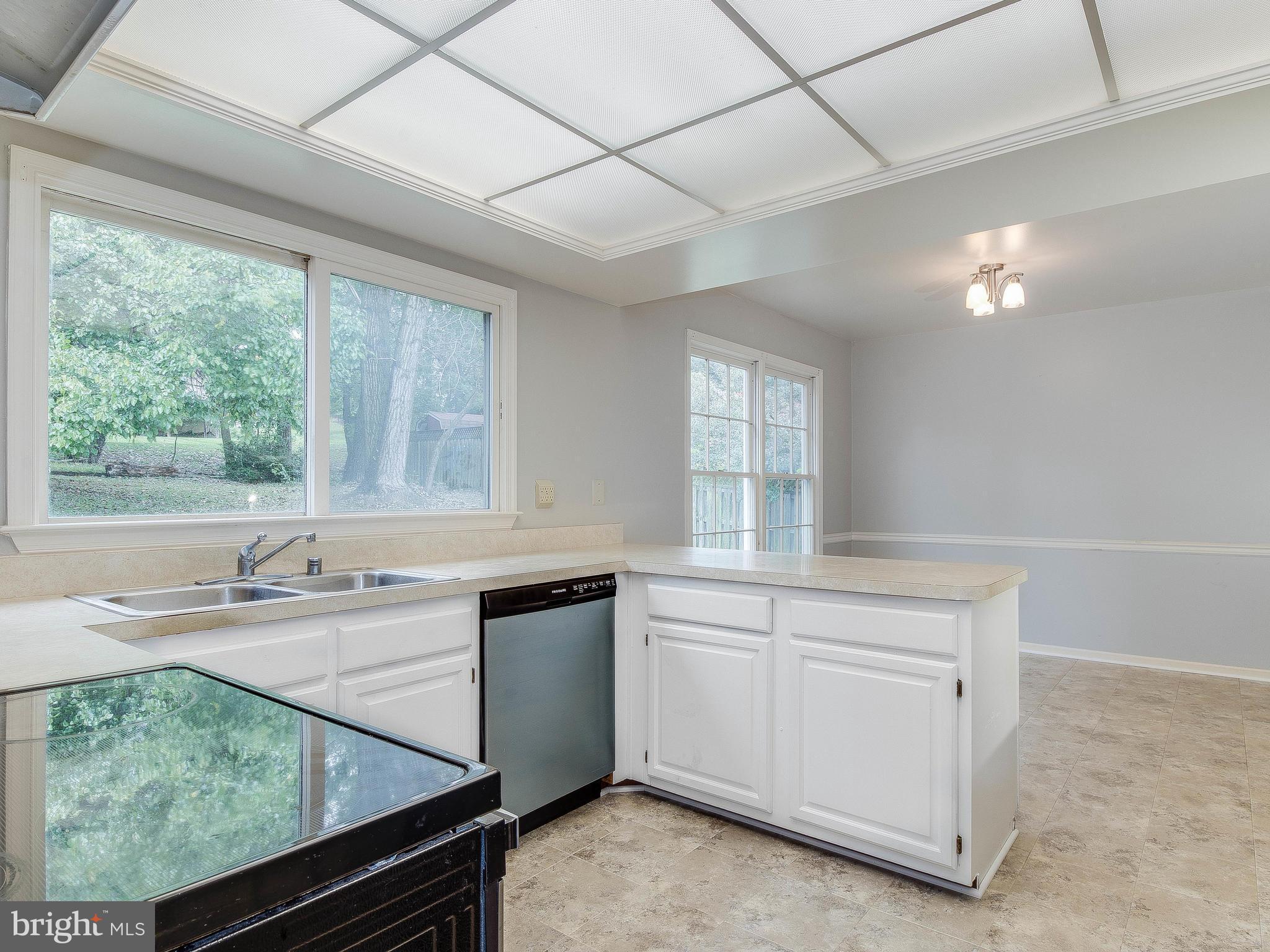 13805 Turnmore Road Silver Spring, MD 20906 - Photo 11 of 29 a kitchen with a sink stove and cabinets