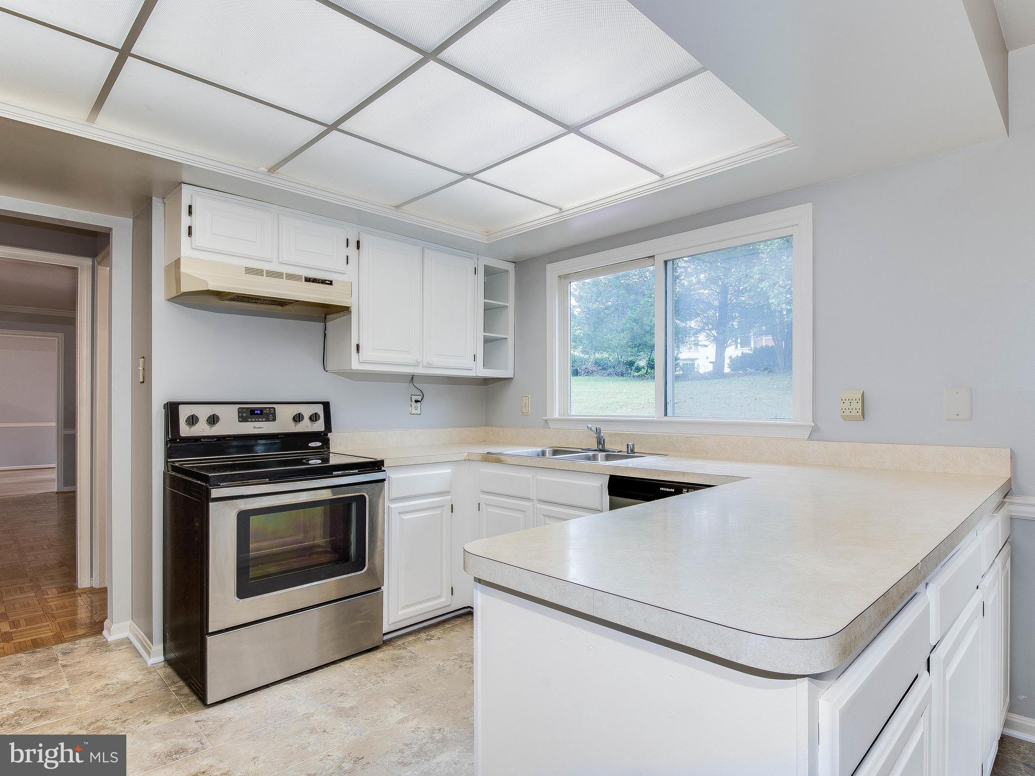 13805 Turnmore Road Silver Spring, MD 20906 - Photo 12 of 29 a kitchen with a stove a sink and a microwave