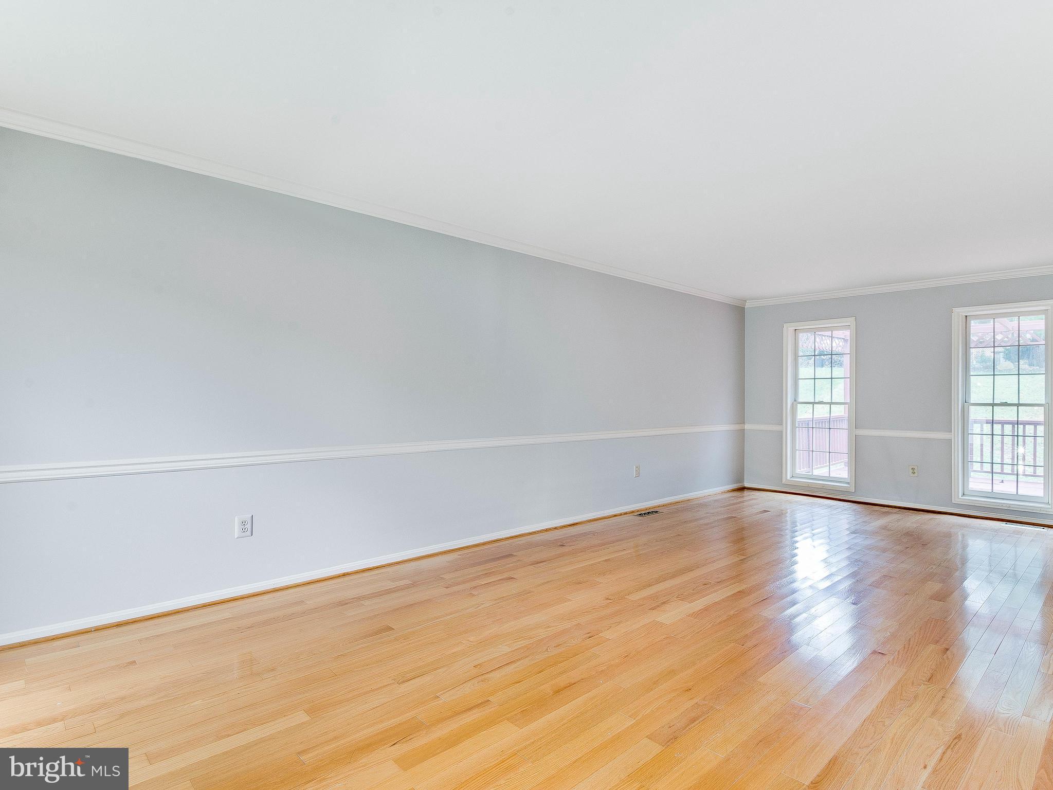 13805 Turnmore Road Silver Spring, MD 20906 - Photo 3 of 29 a view of an empty room with wooden floor and window