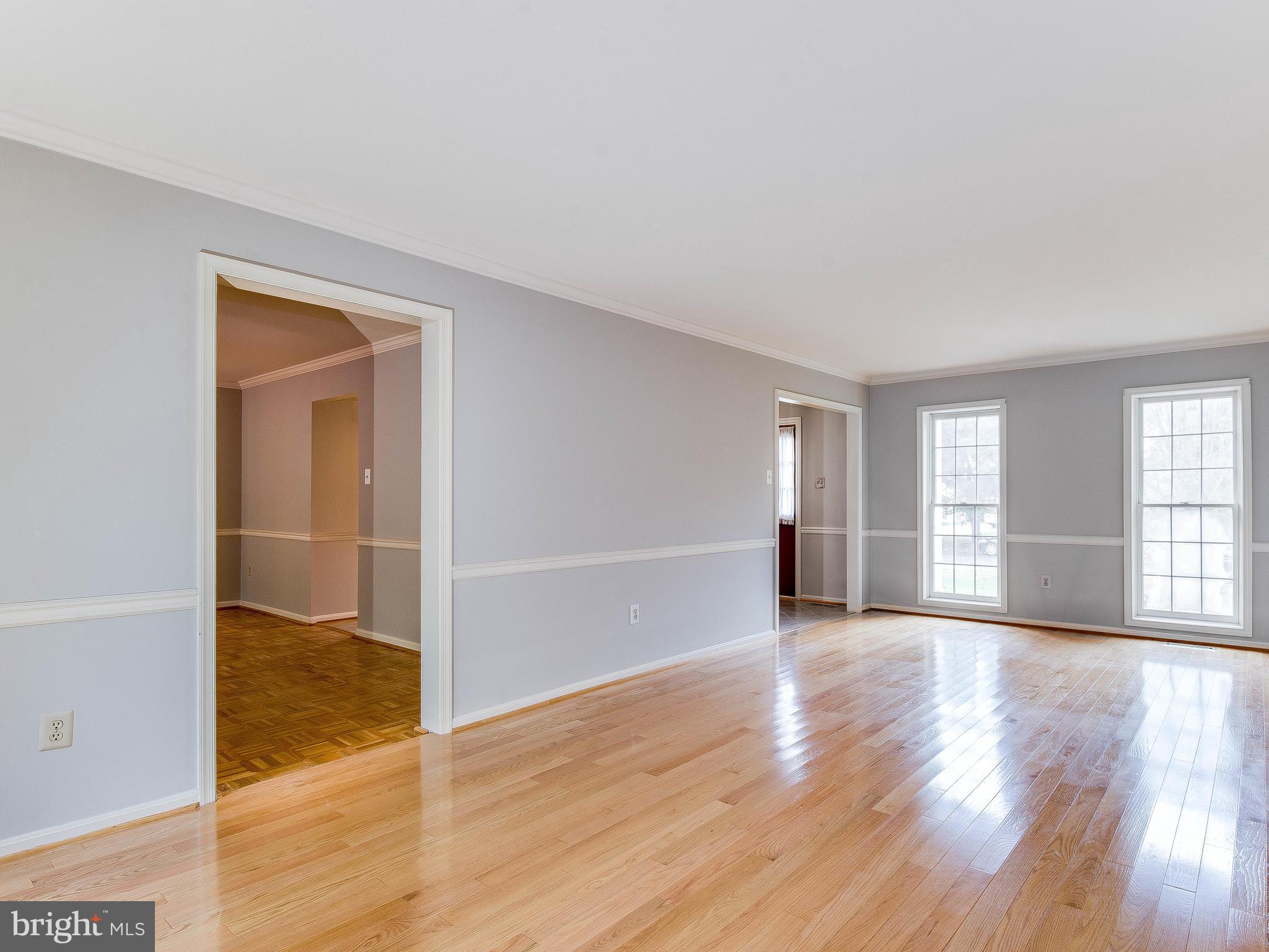 13805 Turnmore Road Silver Spring, MD 20906 - Photo 5 of 29 an empty room with wooden floor and windows