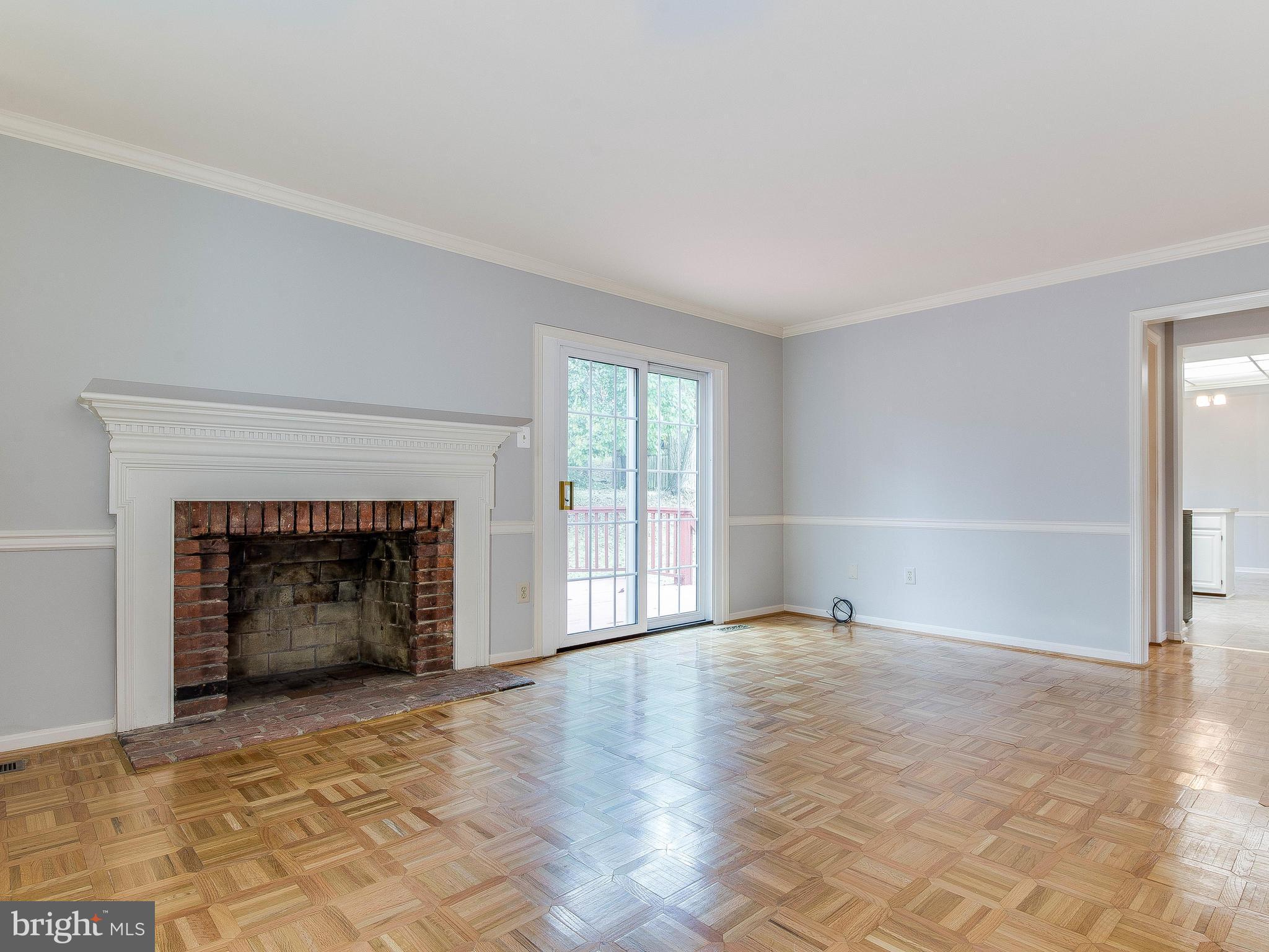 13805 Turnmore Road Silver Spring, MD 20906 - Photo 6 of 29 an empty room with fireplace and windows