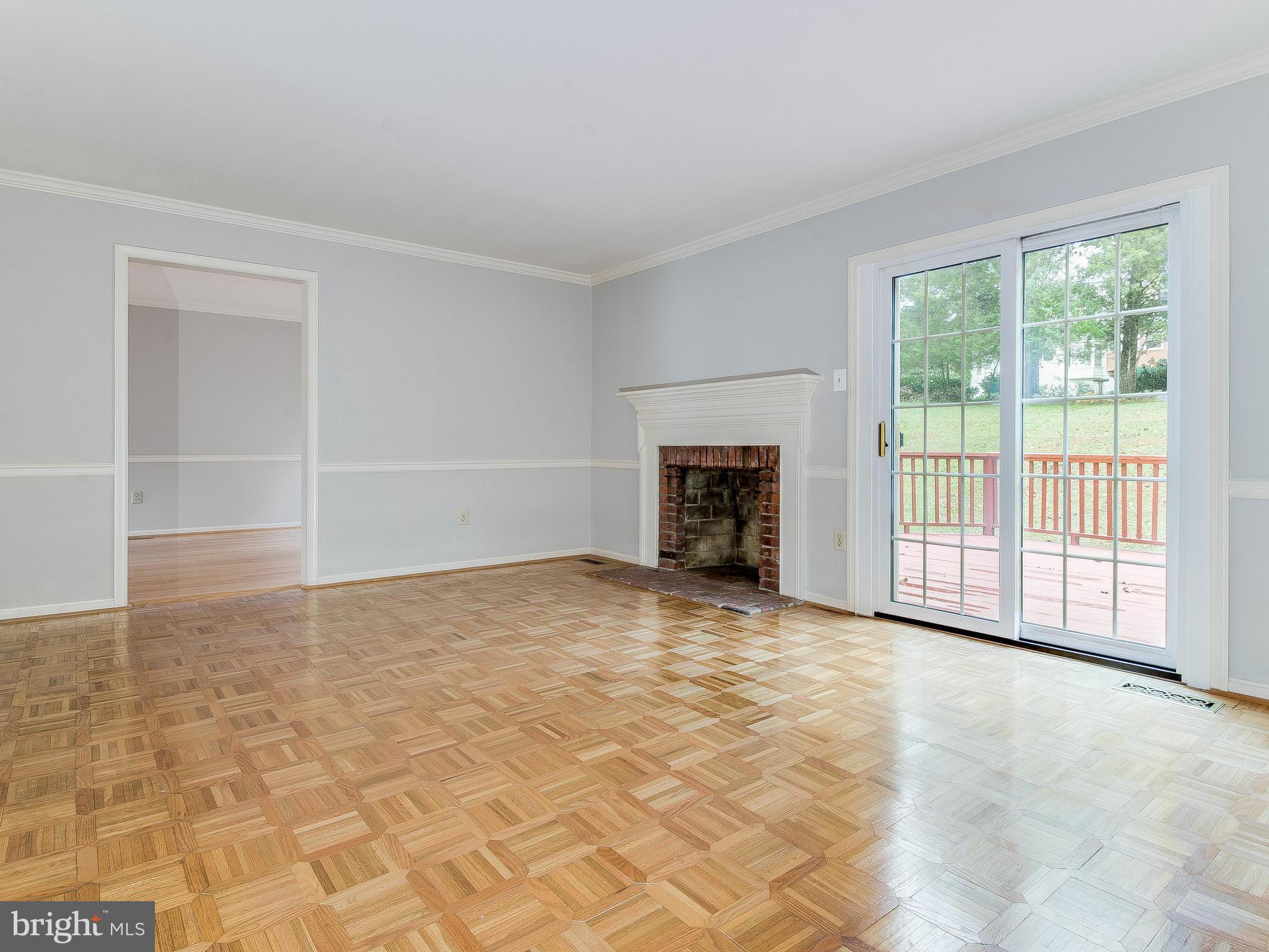 13805 Turnmore Road Silver Spring, MD 20906 - Photo 7 of 29 a view of an empty room with a fireplace and a window