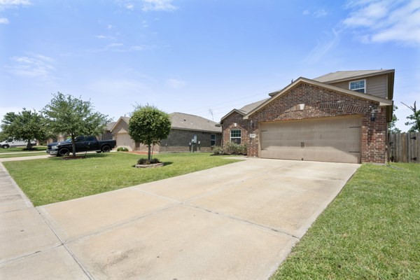 1327 Diamond Drape Drive Rosharon, TX 77583 - Photo 25 of 26 a front view of a house with a yard