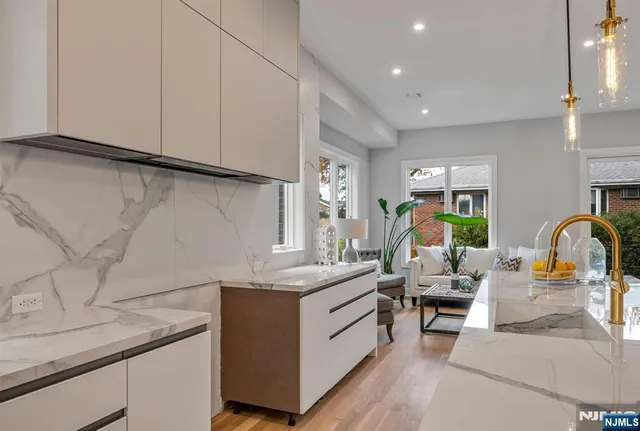 a kitchen with stainless steel appliances granite countertop a sink and a stove