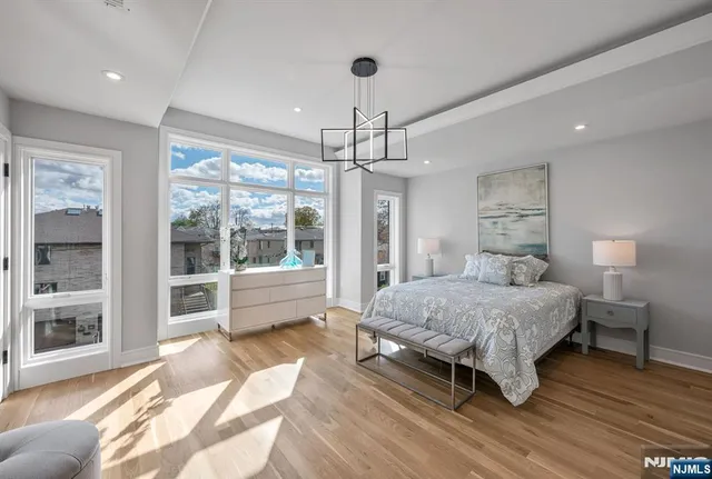 a spacious bedroom with a bed and a large window