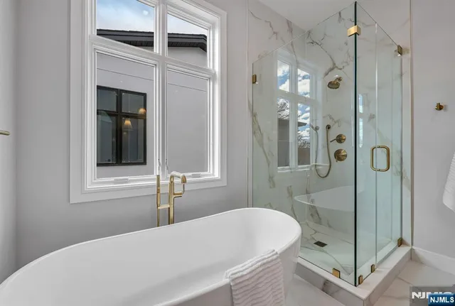 a bathroom with a bathtub and a shower