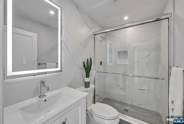 a bathroom with a sink toilet and shower