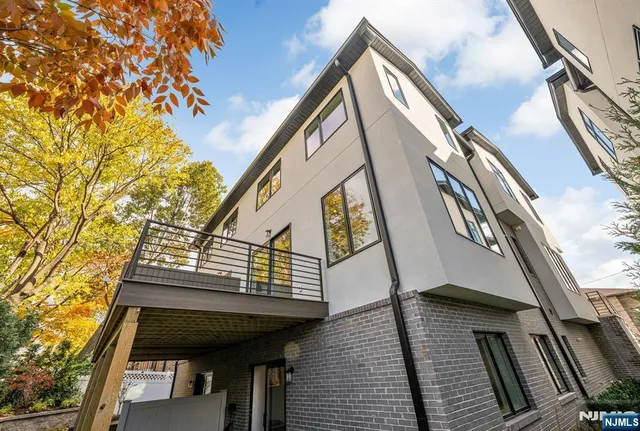 a view of balcony with wooden floor and fence