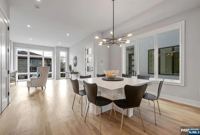 a view of a dining room with furniture wooden floor and chandelier
