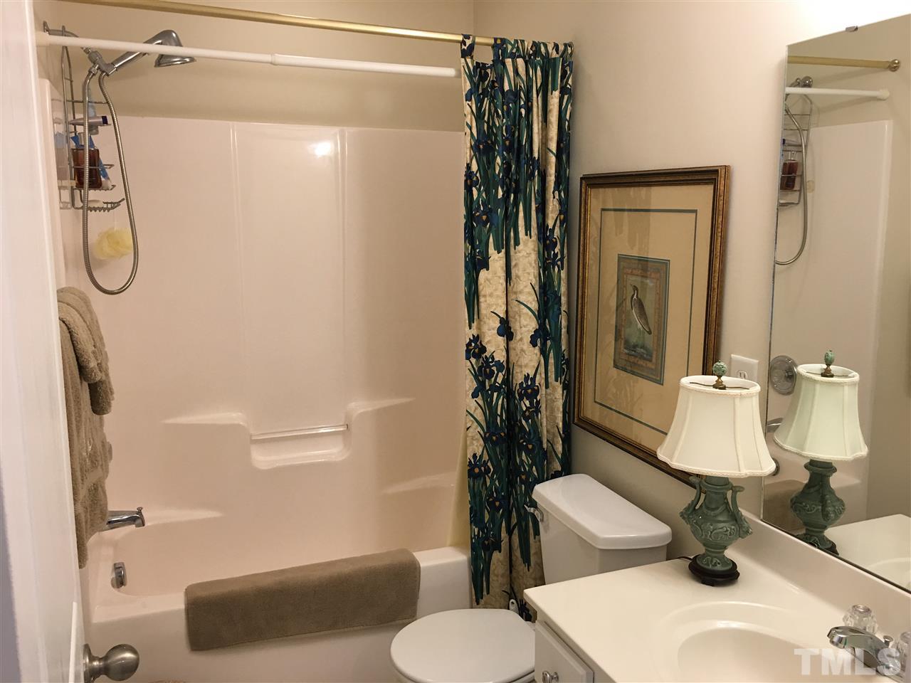 7634 Winners Edge Street Raleigh, NC 27617 - Photo 14 of 22 a bathroom with a sink toilet and shower
