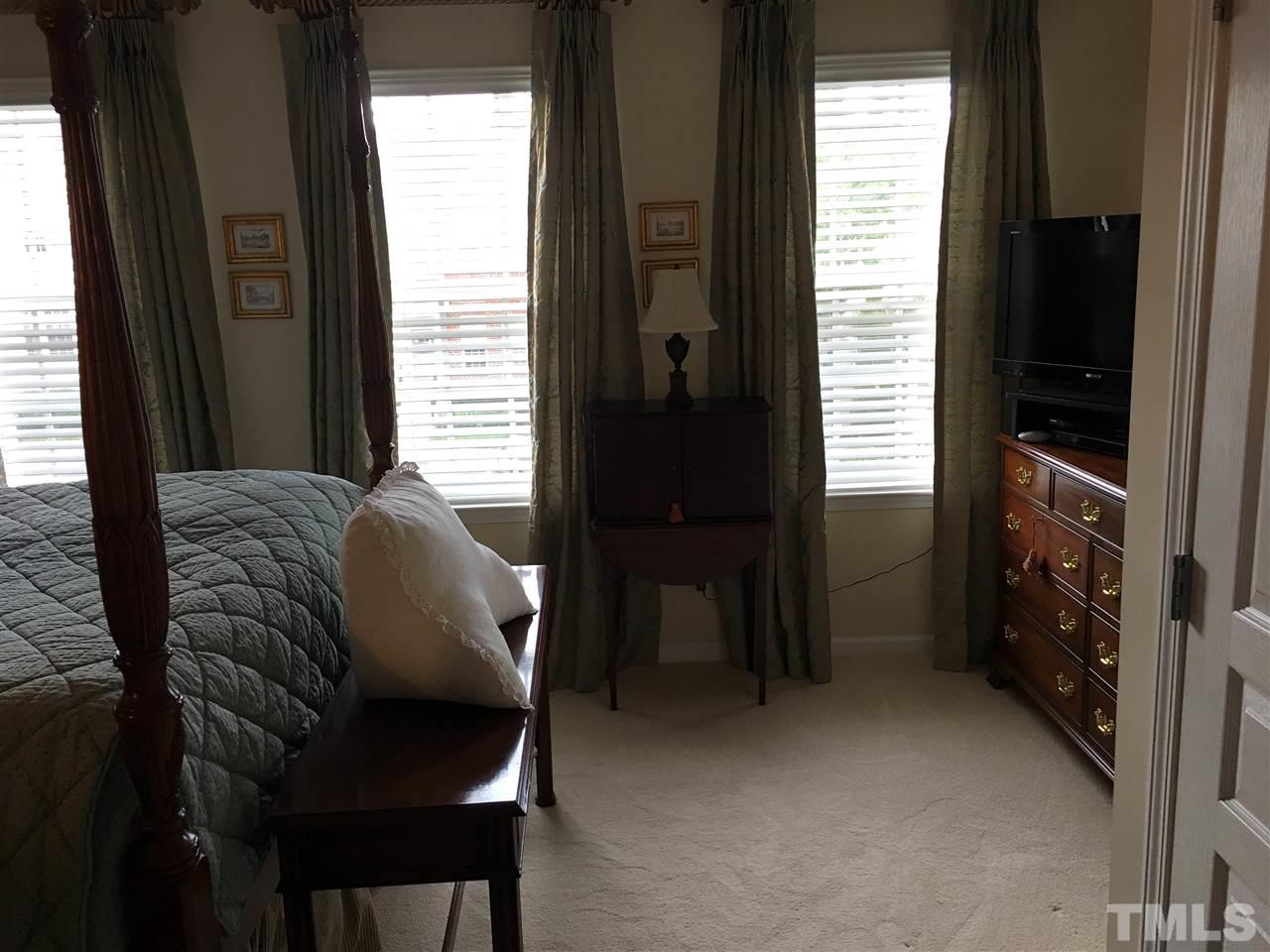 7634 Winners Edge Street Raleigh, NC 27617 - Photo 17 of 22 a living room with furniture and a flat screen tv